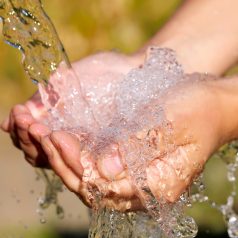 Woman's hands with water splash